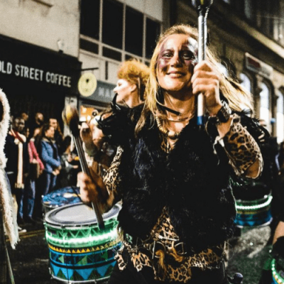 Katumba Halloween Carnival Parade Liverpool October 2022, Drummers withcentral smiling woman by Nick Mizen - drumming liverpool such as drumming events liverpool to sum up liverpool rhythm workshops - Drumming Group Liverpool